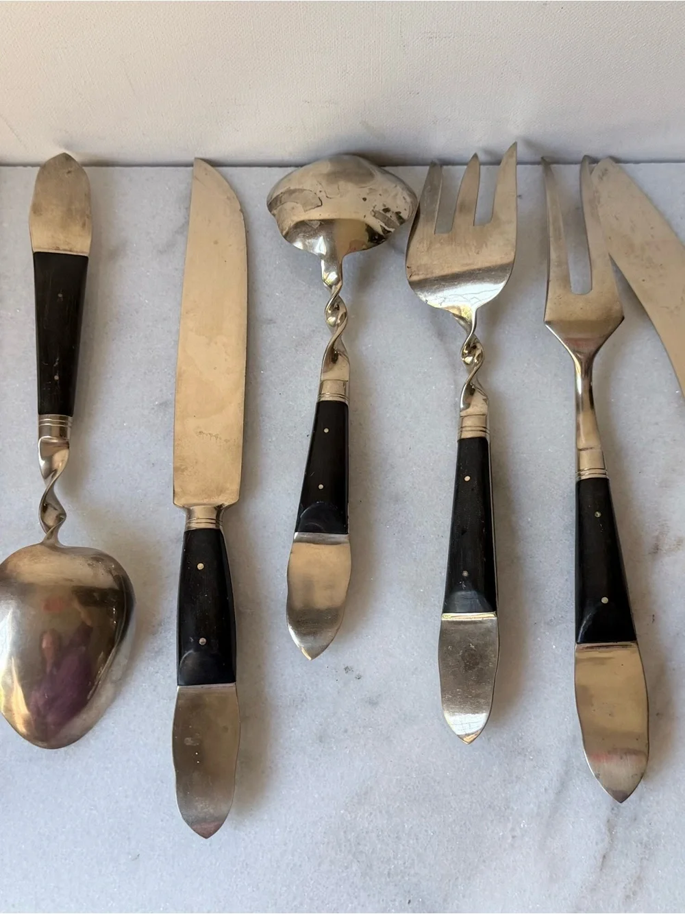 set consists of vintage Thai brass or bronze utensils with dark wooden handles.
